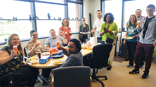Diverse group of employees enjoying time together in a break room