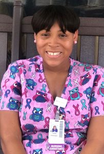 Young woman wearing nursing badge