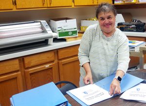 woman assembling school binders