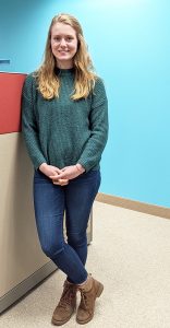 Woman leaning against cubicle