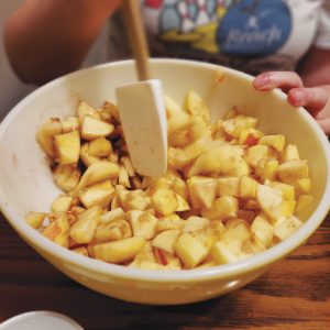 Cubed apples in a bowl with cinnamon