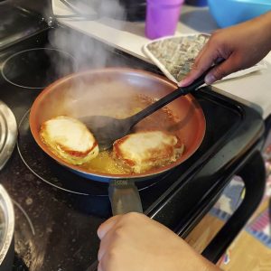 Pork chops seared in pan.