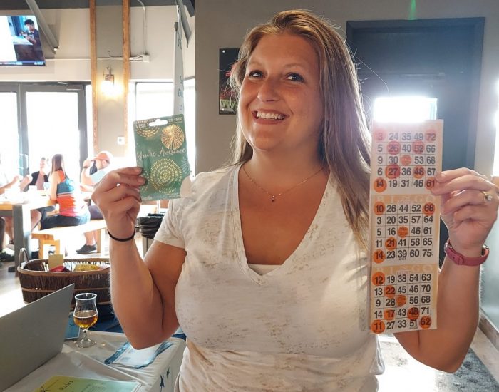Lady holding prize after winning bingo.