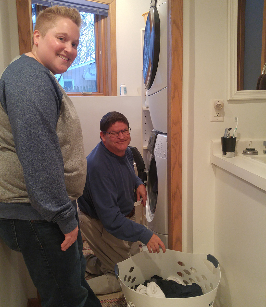 Jim Anderson doing laundry Reach's semi-independent living skills services assists Jim with learning how to do his own laundry.
